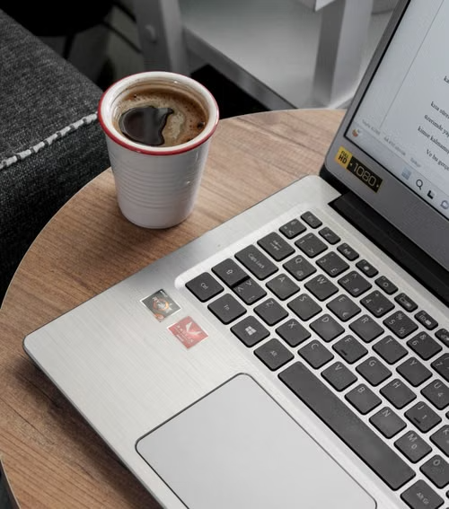 Laptop and coffee while working on a business website